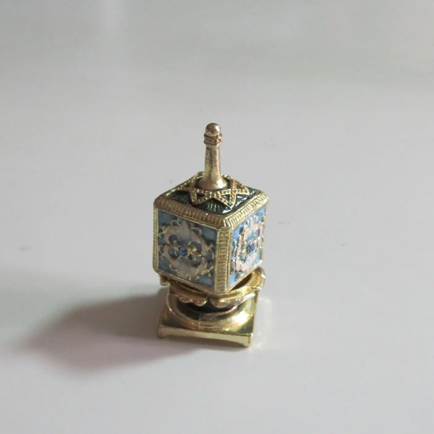 Light blue box spinning top by Ami Decorative Products