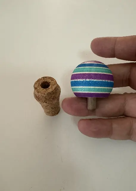 A spinning top that is also a wine bottle stopper by Alberto Segale