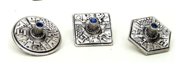 Metal spinning tops by Meir Cohen