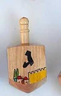 Wooden spinning tops with a painting of the walls of Jerusalem by Meir Cohen