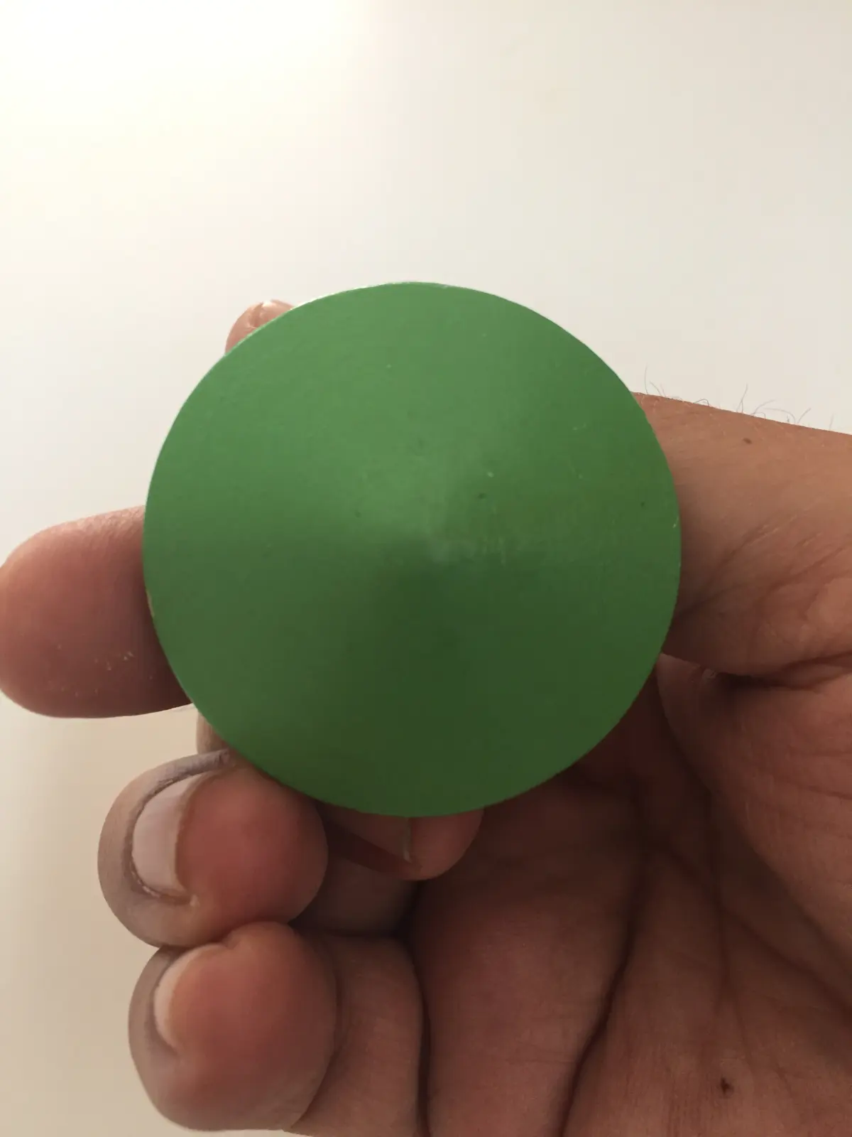 Green spinning top with white and pink circles, Hungary
