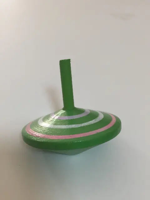 Green spinning top with white and pink circles, Hungary