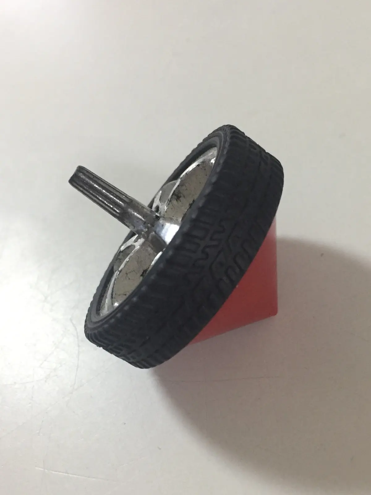 A spinning top made from a toy car wheel, Singapore