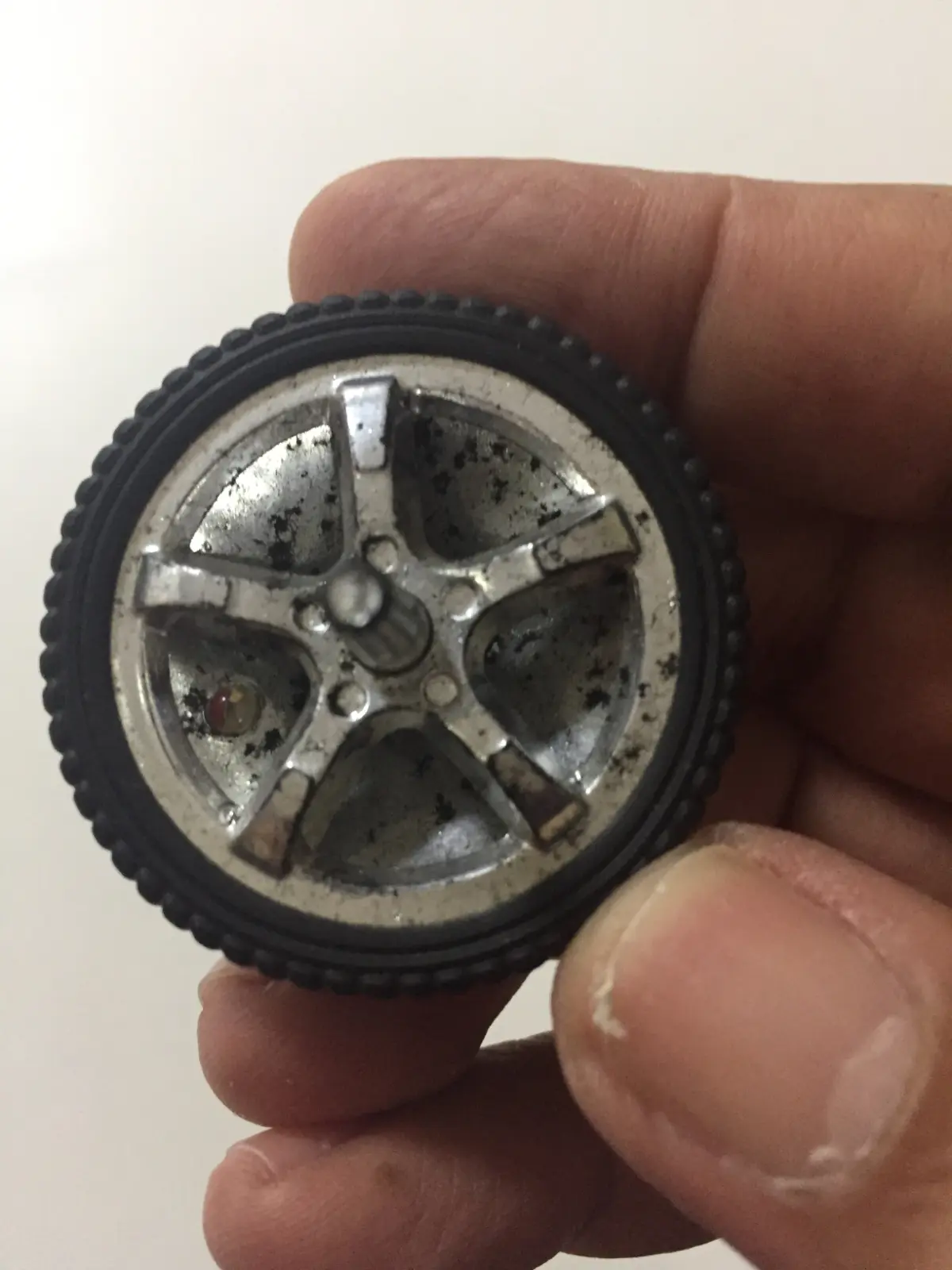 A spinning top made from a toy car wheel, Singapore