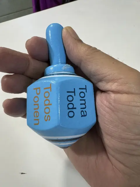 A traditional Mexican wooden spinning top for a game called "Toma Todo", also known as "Pirinola".