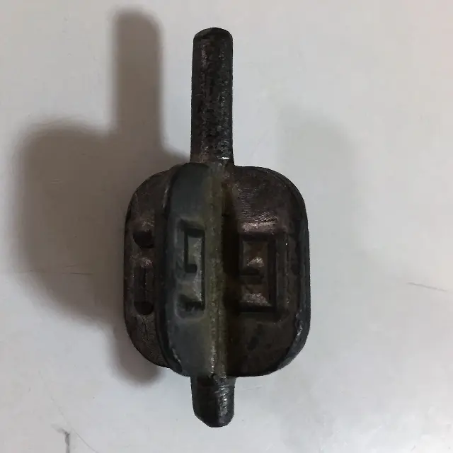 A winged lead spinning top with the inscription "נ,ג,ה,פ."