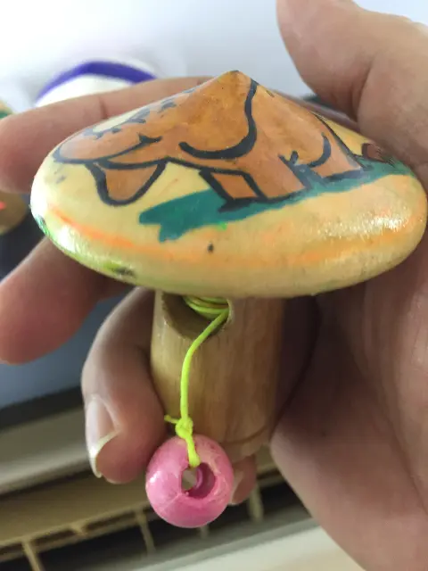 Spinning top with launcher and painting of a bathing elephant from Thailand