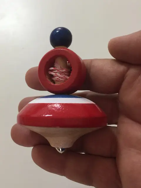 spinning top with ring launcher and red, white and blue thread from Prague, Czech Republic