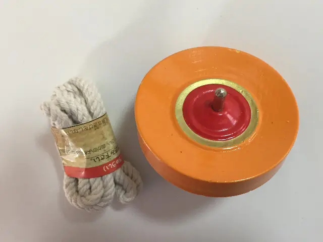 Orange floor spinning top with spinning thread from Japan