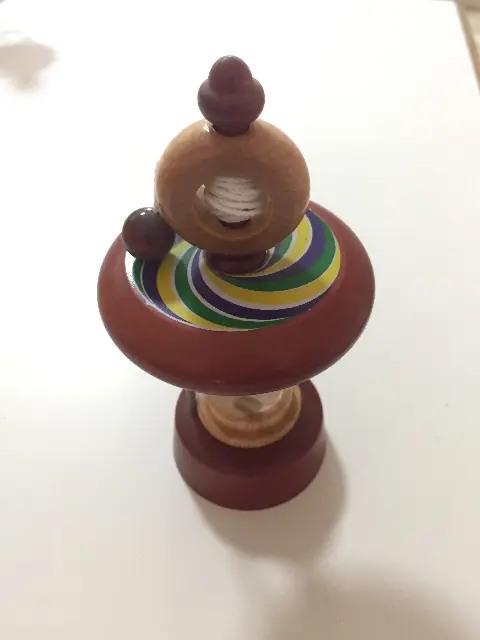 Colorful spinning top with launcher ring and string from Taiwan, bought in Prague