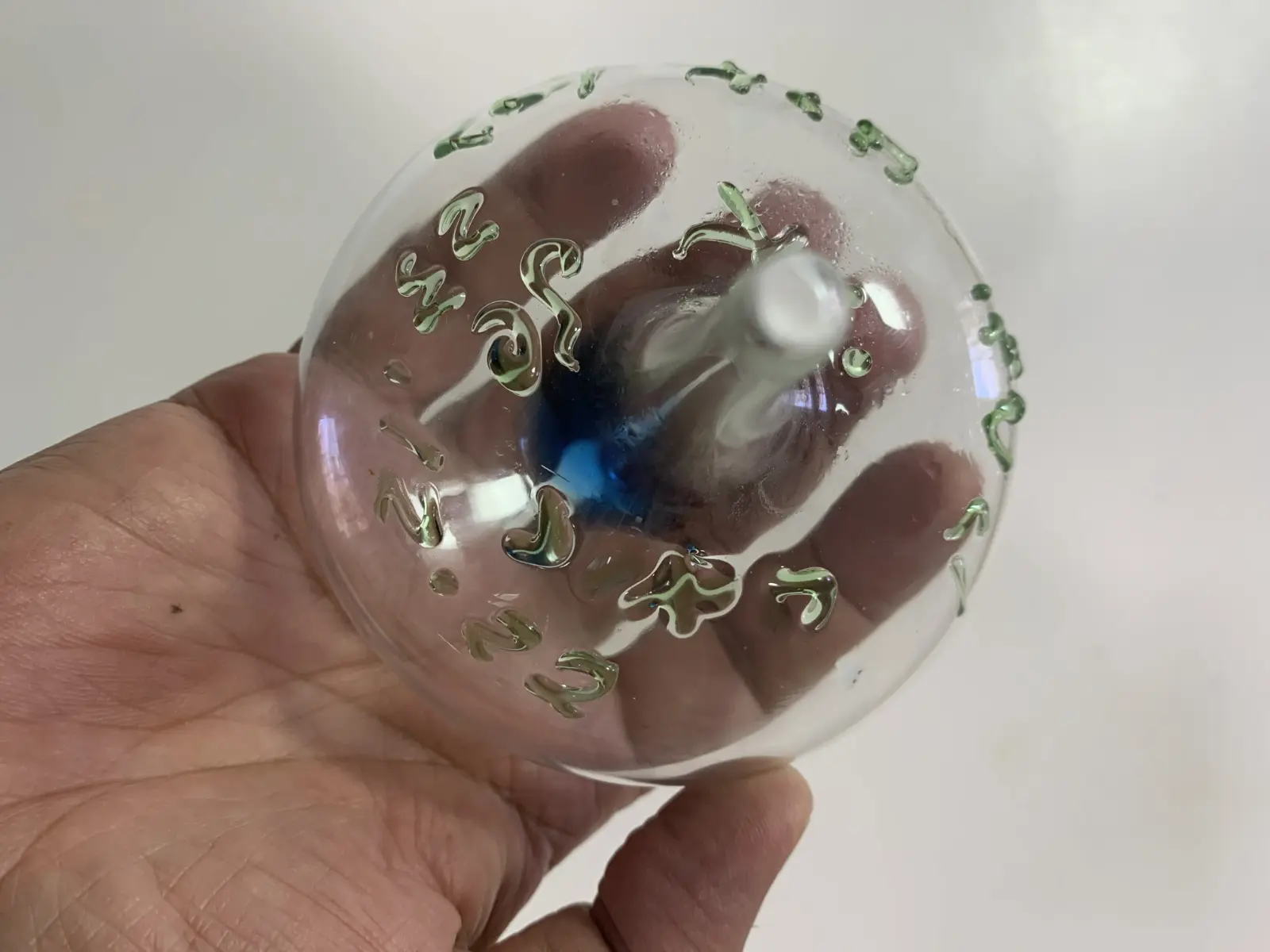 Glass spinning tops with blue liquid from the workshop of Yitzhak Cohen Arazi as part of the Chanukah activities of the Uri Foundation 2022