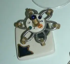 Ceramic Hanukkah spinning top and metal rings by Eran Graveler
