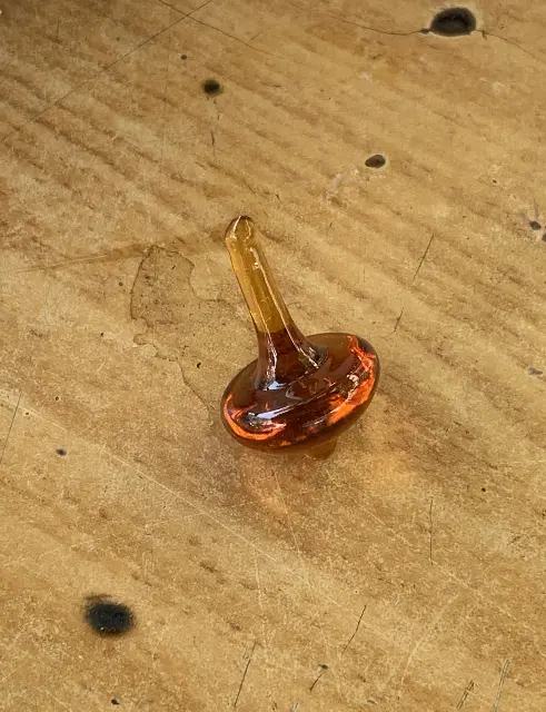 Brown glass spinning top by Naftali Hazan