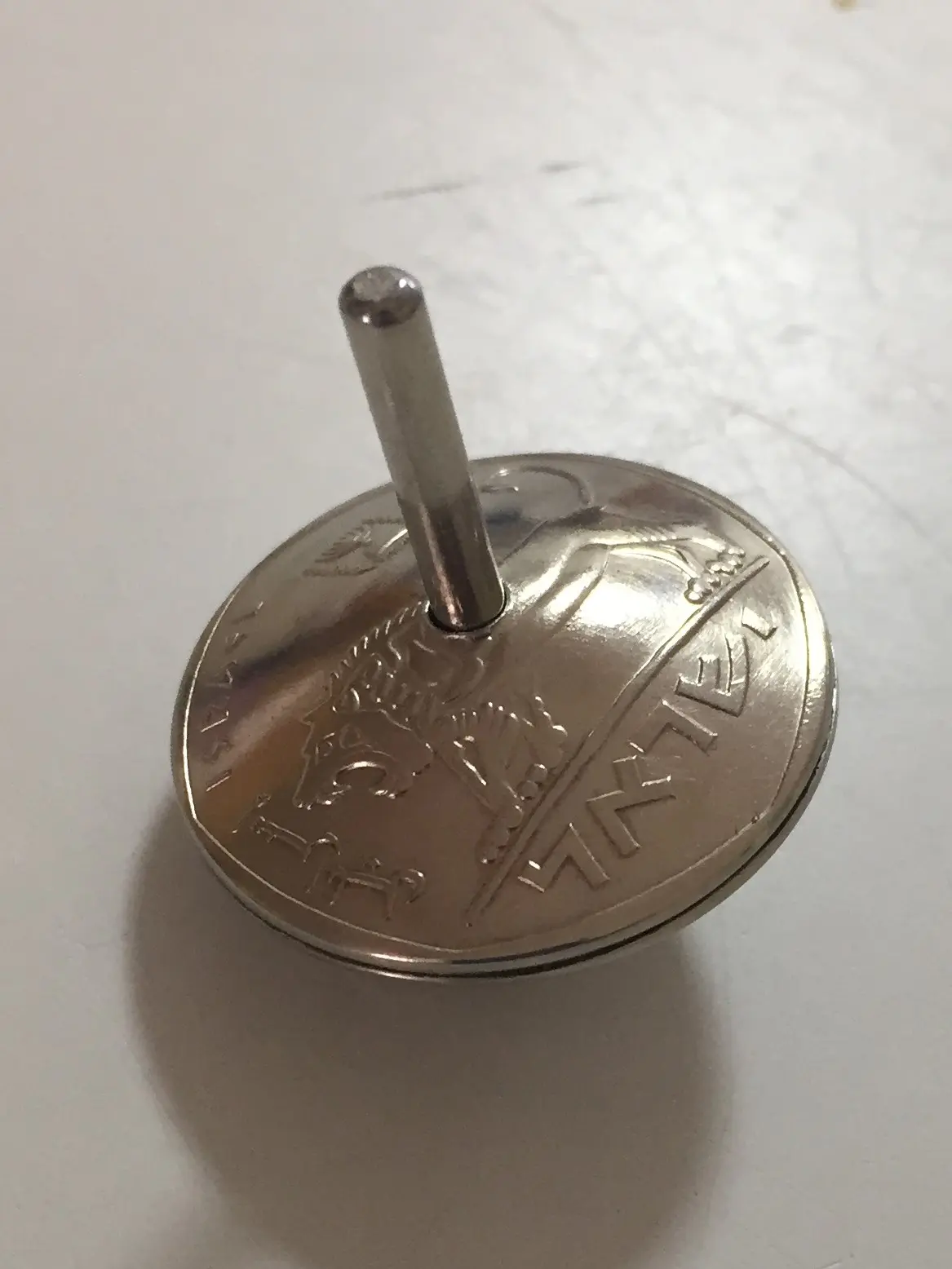 Spinning top 100 shekel coin Marin Shavit