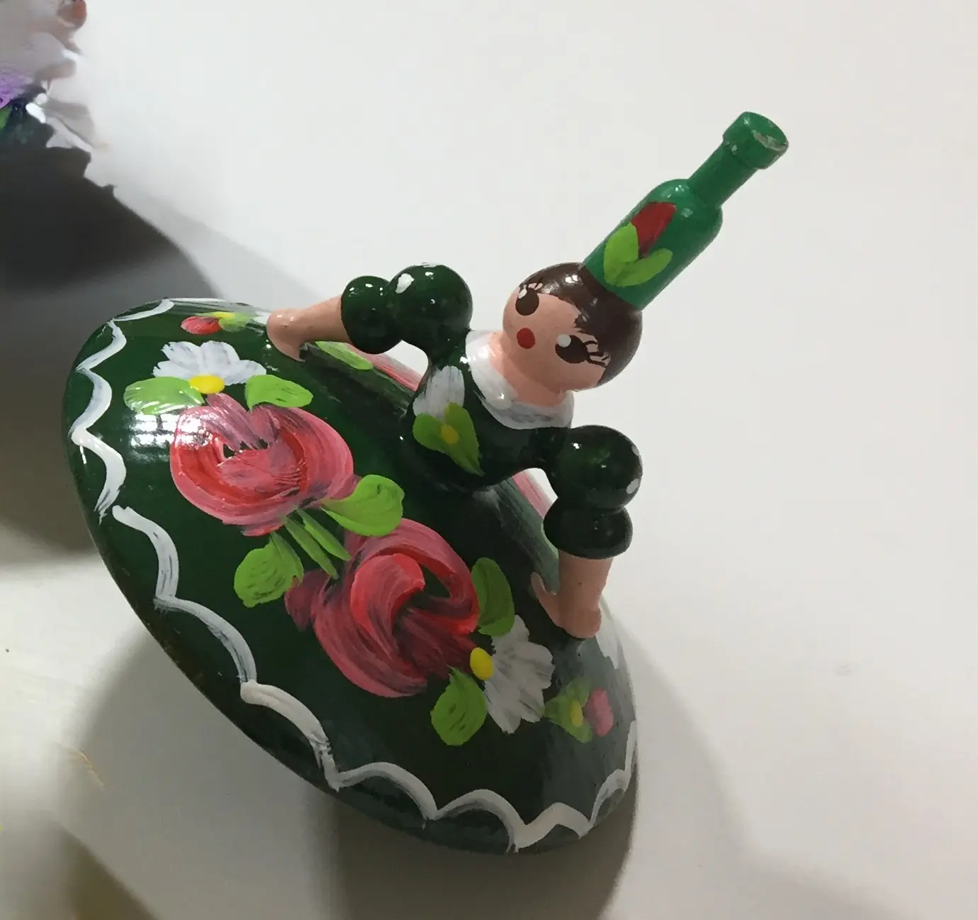 Spinning top dancer with a green dress from Hungary