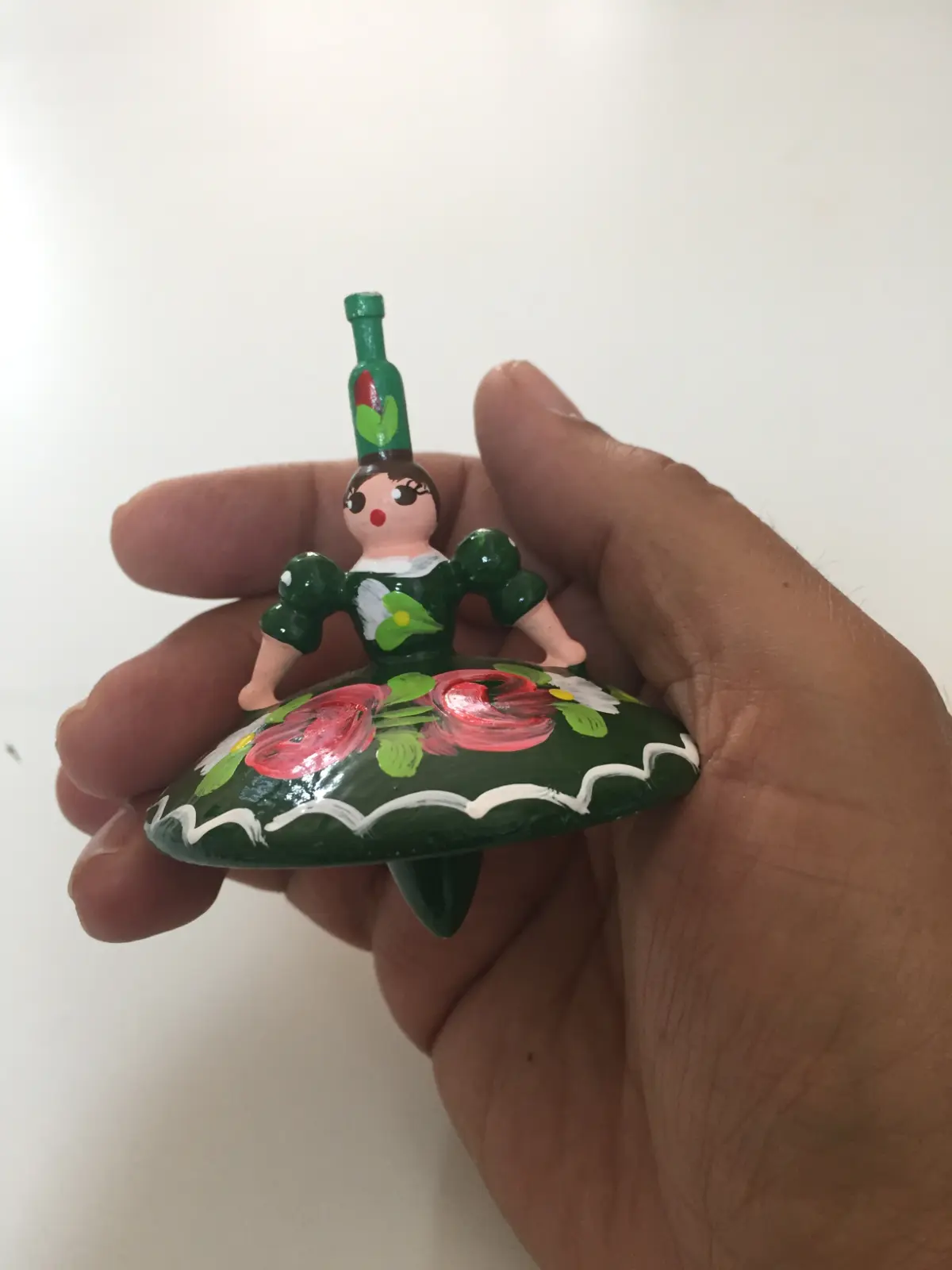 Spinning top dancer with a green dress from Hungary