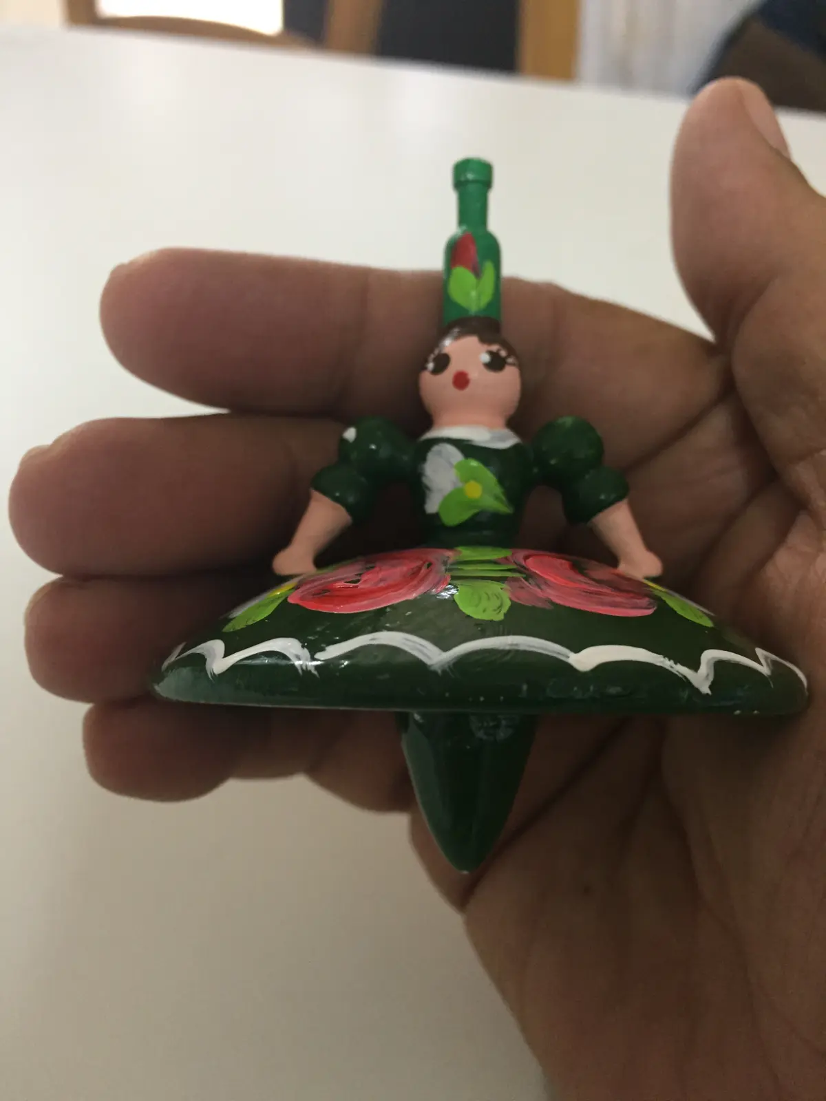 Spinning top dancer with a green dress from Hungary